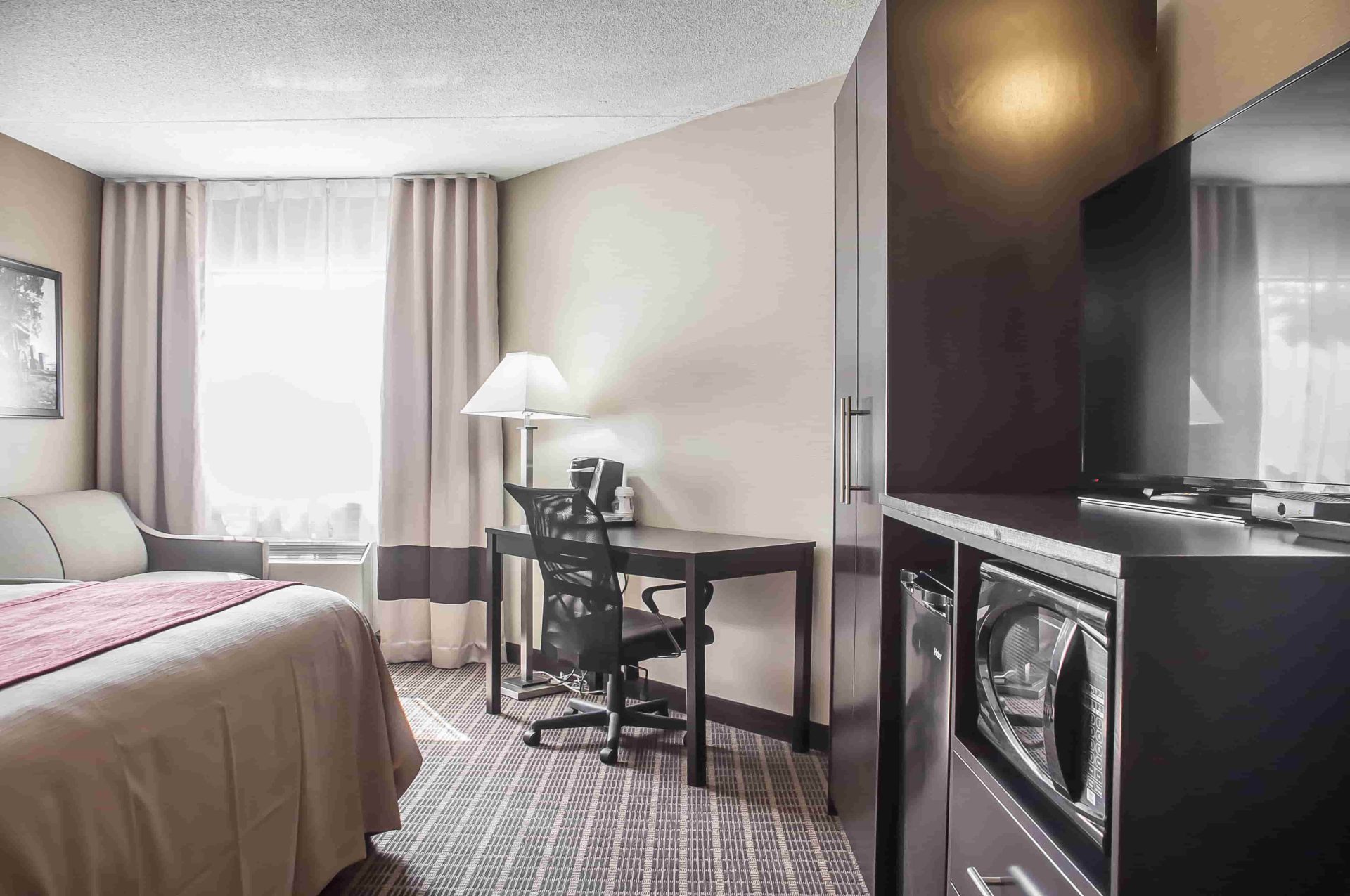 Comfort Inn Fort Erie king bed suite with desk and tv